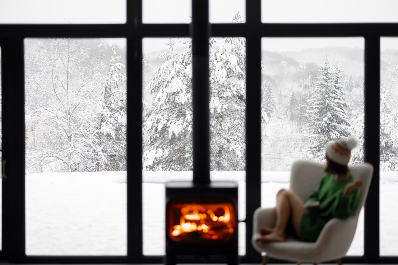 Snow-covered Lake Tahoe home in winter with pine trees and mountains in the background