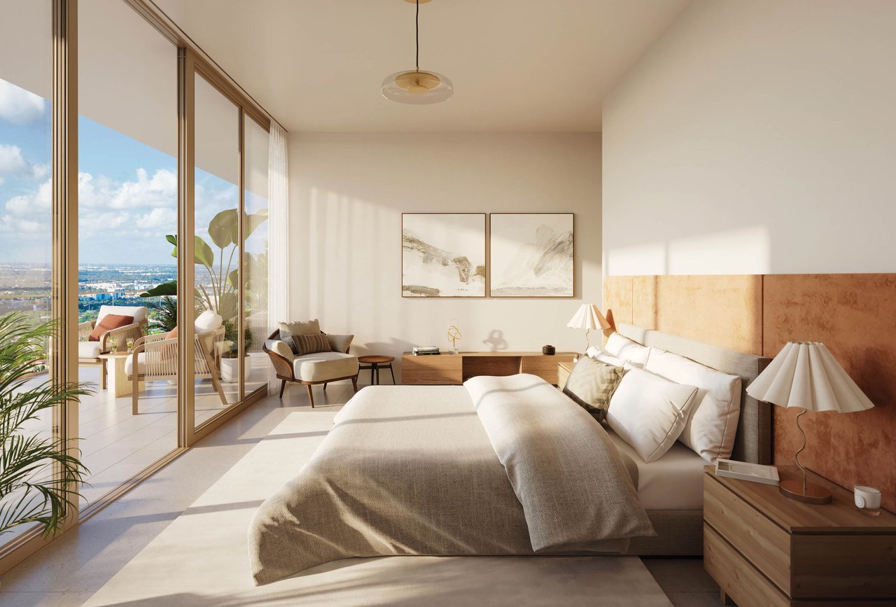 Furnished bedroom with a king-size bed and floor-to-ceiling glass doors opening to a balcony with city views.
