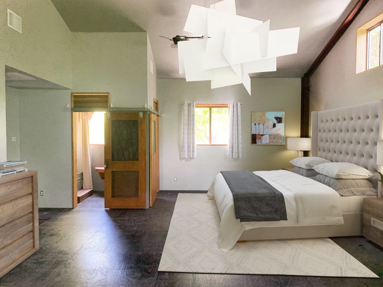 Bedroom with vaulted ceiling, exposed beam, sculptural pendant, and dark floors at 640 Tillery Street in East Austin.