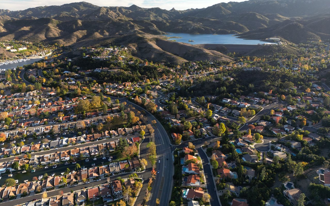 Aerial view of Calabasas neighborhoods, rolling hills, and a reservoir.