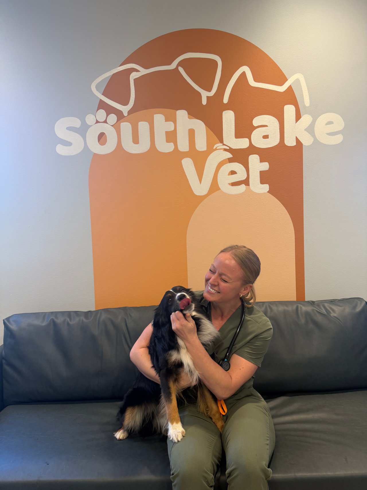 Mookie giving Dr. Turner some affection at South Lake Vet off Platt Springs Road