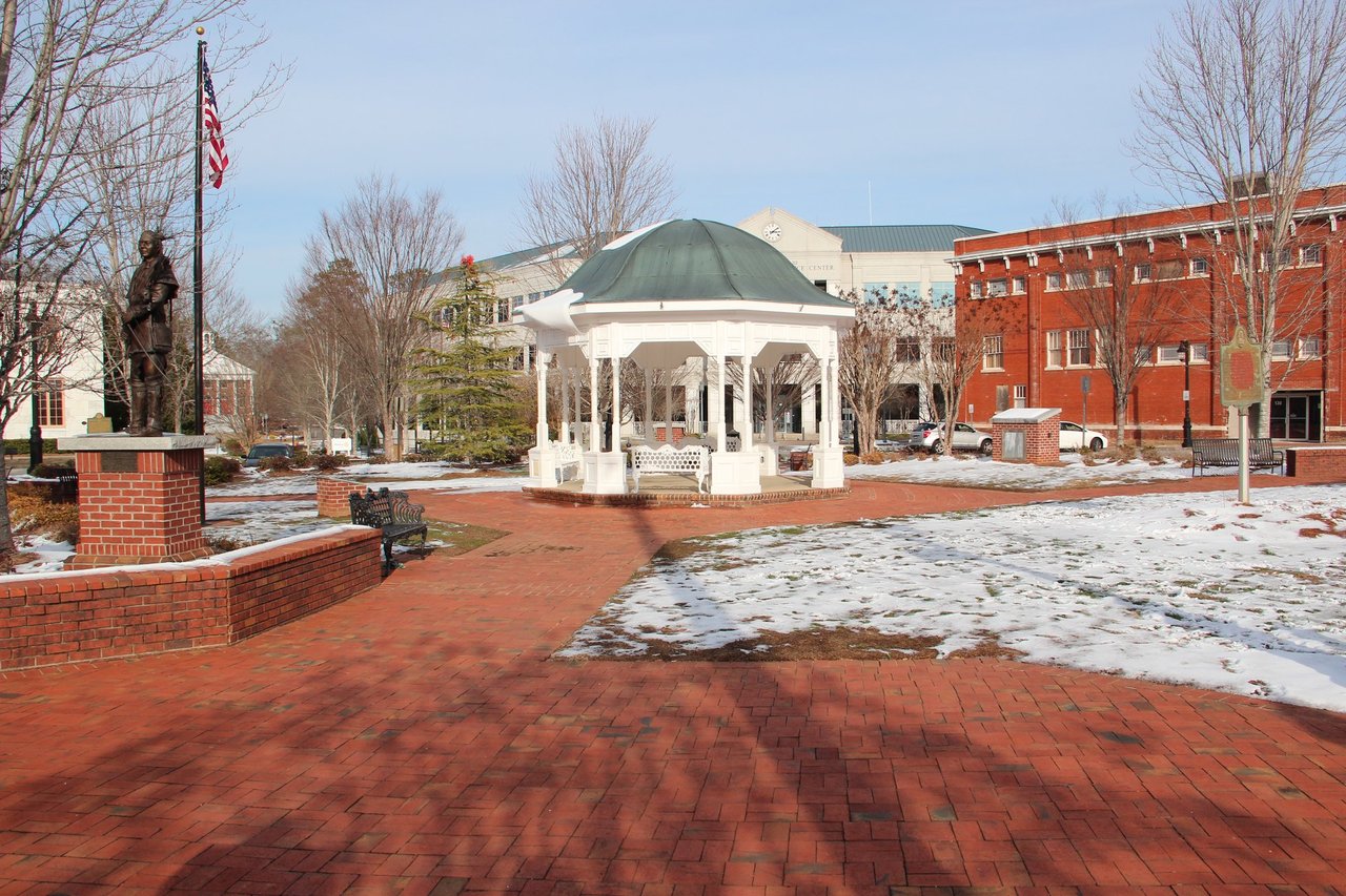 Historic Canton, Georgia town square with white gazebo, brick buildings and memorial statue