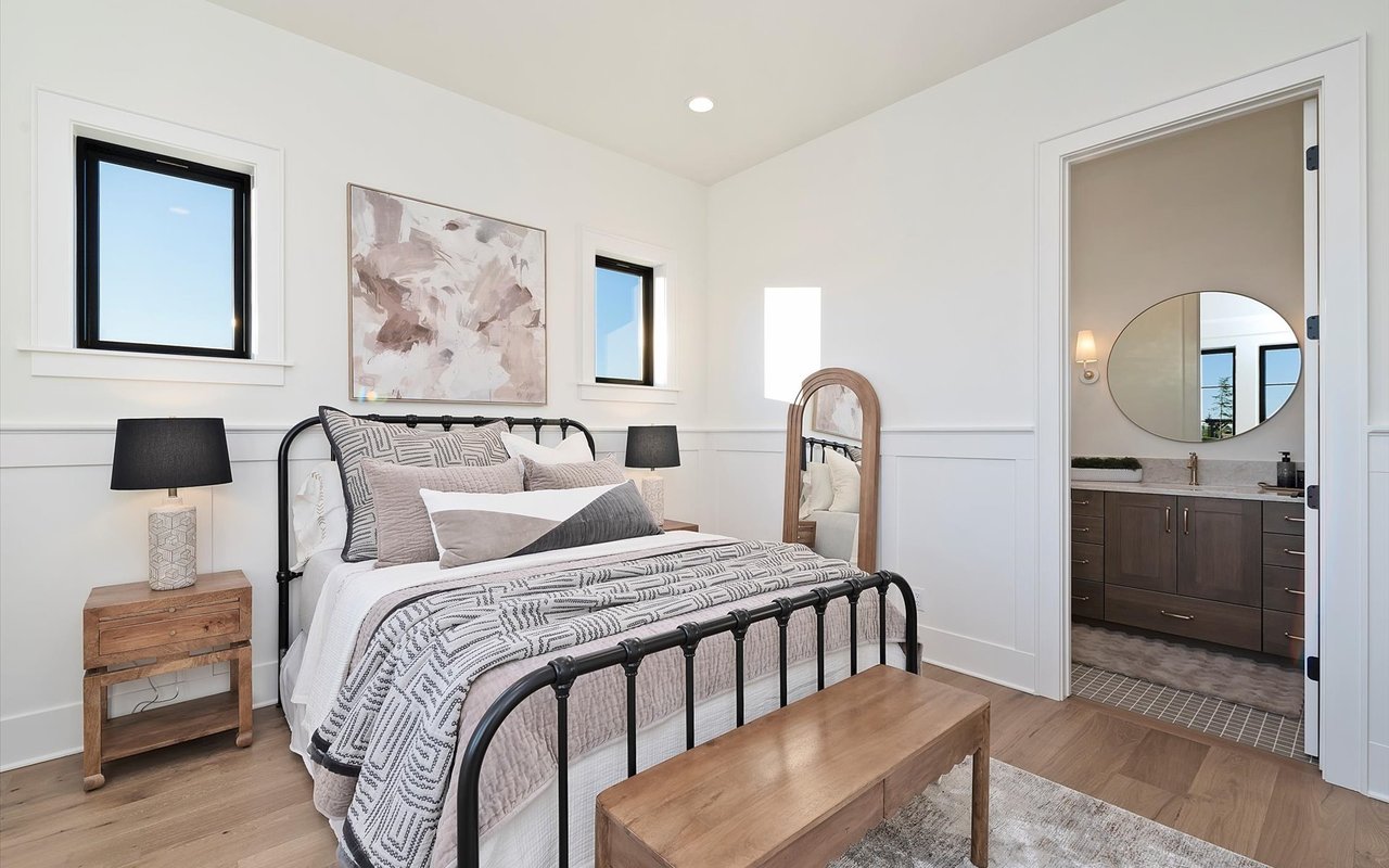 Junior suite featuring black metal antique bed frame and wood furniture