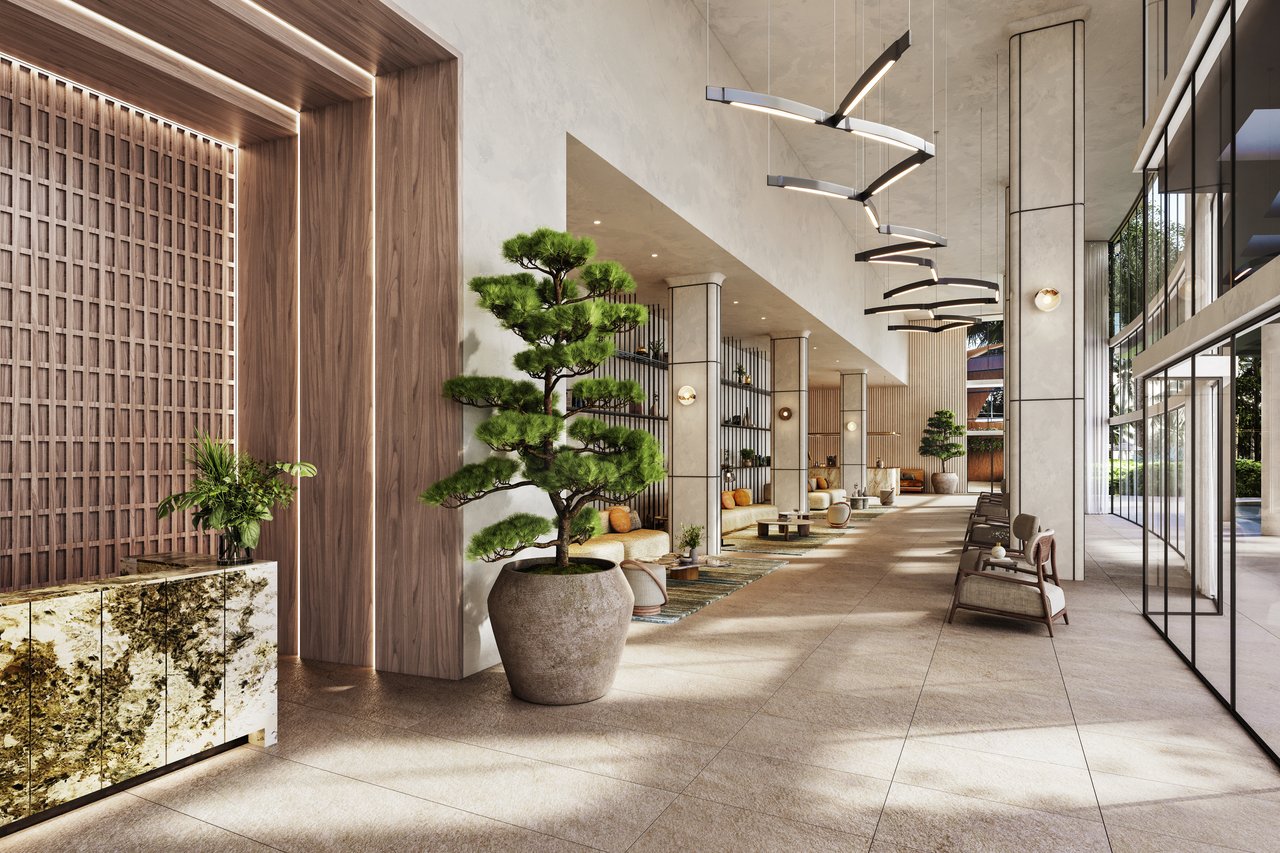 NEXO Residences lobby with sculptural pendant lights, potted trees, and floor-to-ceiling windows.