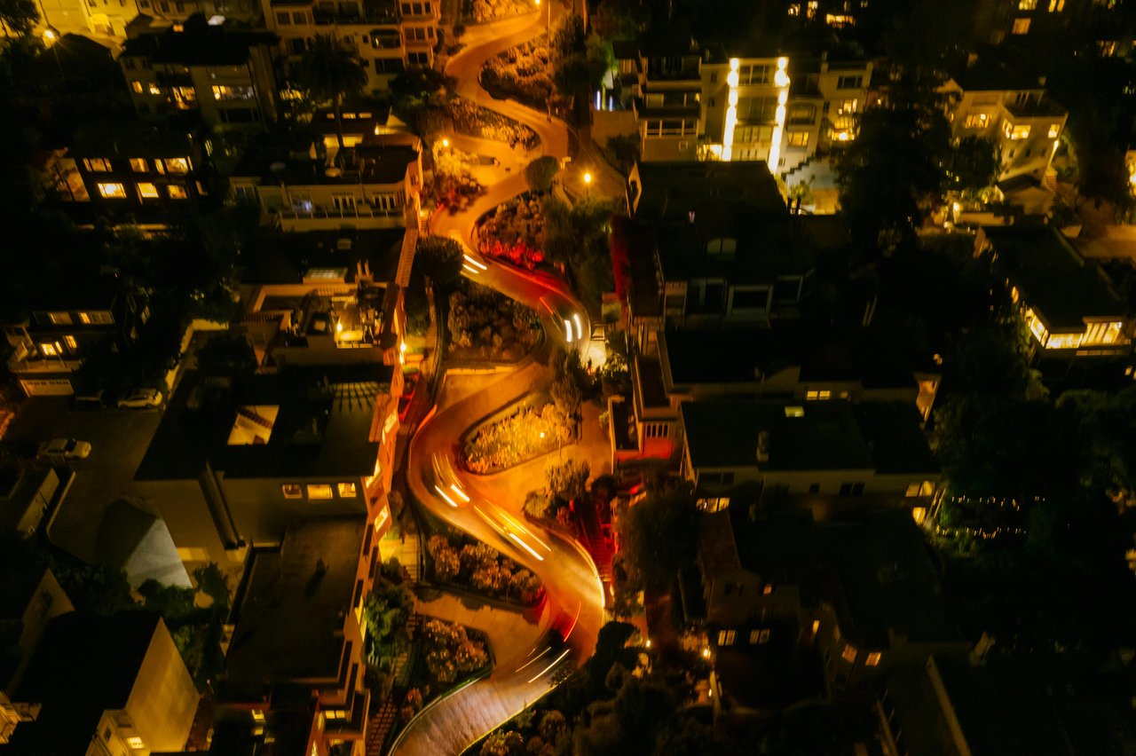 Aerial night view of Lombard Street in Russian Hill, San Francisco with city lights glowing below