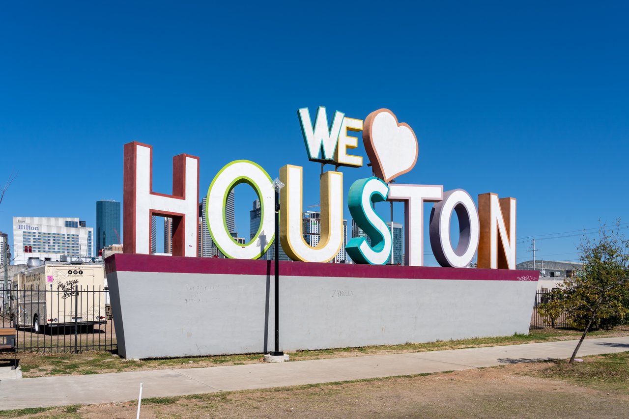 Colorful We Love Houston sign with city skyline in background near Sawyer Yards arts district