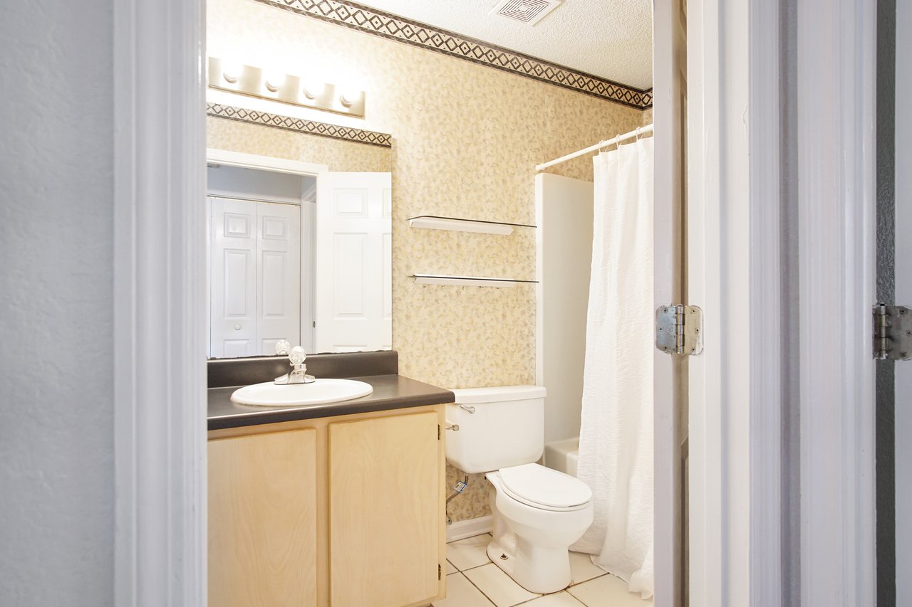 A clean bathroom featuring a toilet and a shower, designed for functionality and comfort.