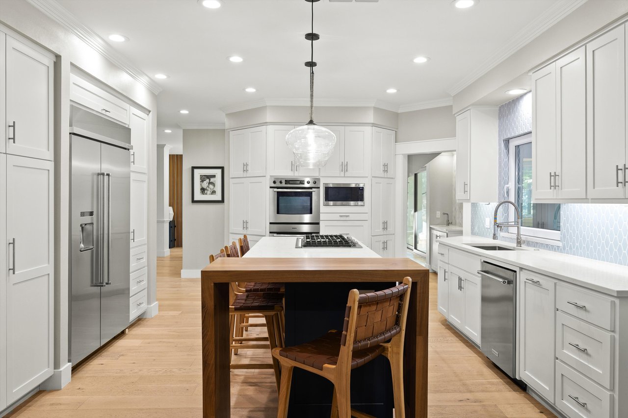 Updated kitchen with large island and stainless-steel appliances