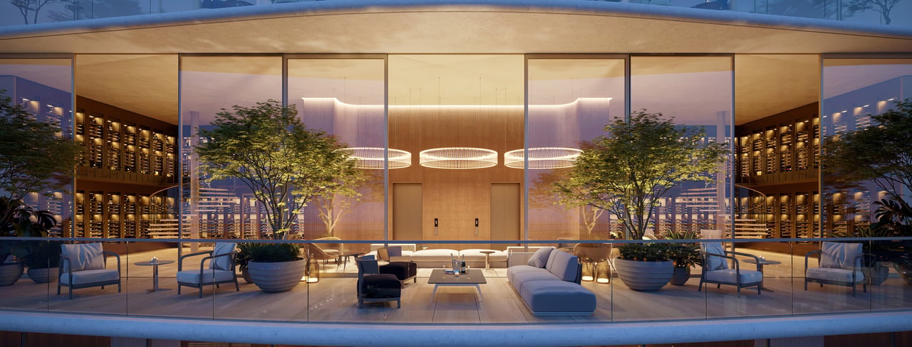 Furnished residential lounge with glass walls, indoor trees, circular pendant lights, and views of surrounding buildings.