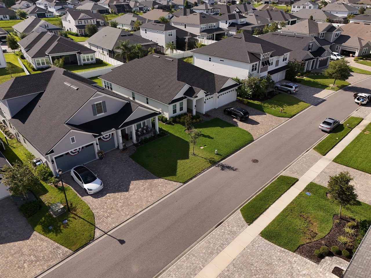 Aerial view of Silverleaf Village homes along a residential street with lawns and driveways.