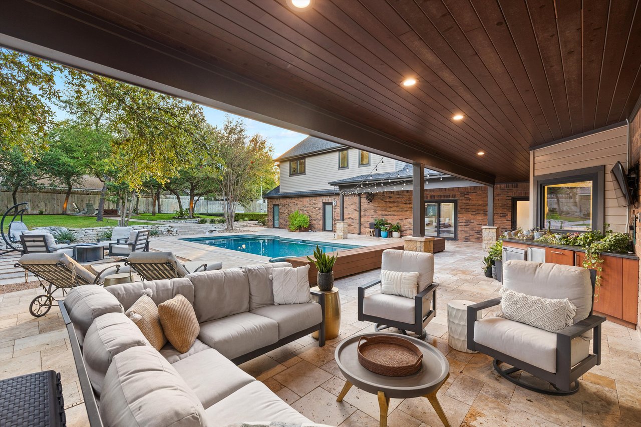 Covered outdoor lounge with outdoor fridge and ice maker