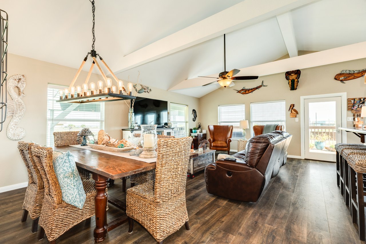 Interior photo of a large coastal home in Freeport, TX with open living space, multiple seating areas, and family-friendly layout perfect for entertaining.