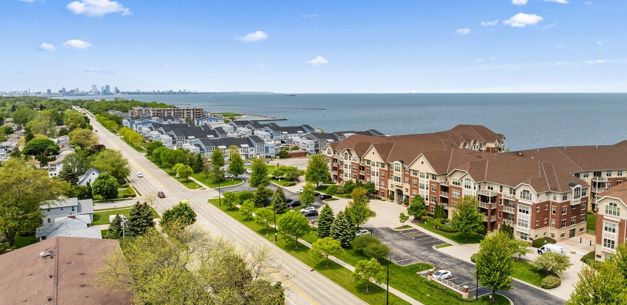 Aerial view of The Landing condos in St. Francis, Wisconsin overlooking Lake Michigan with downtown Milwaukee in the distance.