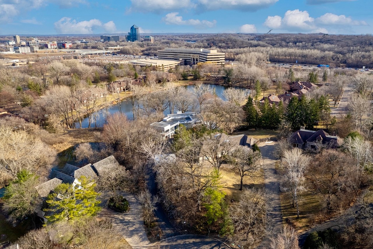 Aerial view of luxury homes, winding streets, mature trees, and ponds in Edina’s Dewey Hill neighborhood