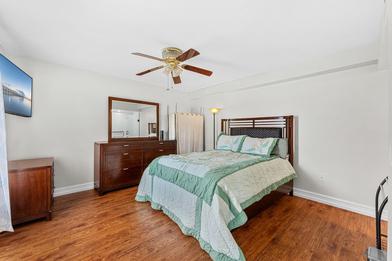 Bedroom with ceiling fan, natural light