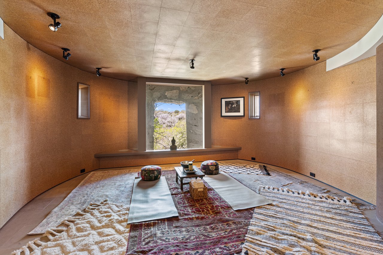 Yoga and meditation studio finished in cork with a curved ceiling and a framed hill country window, 4002 Tyx Trail, Spicewood, Texas.