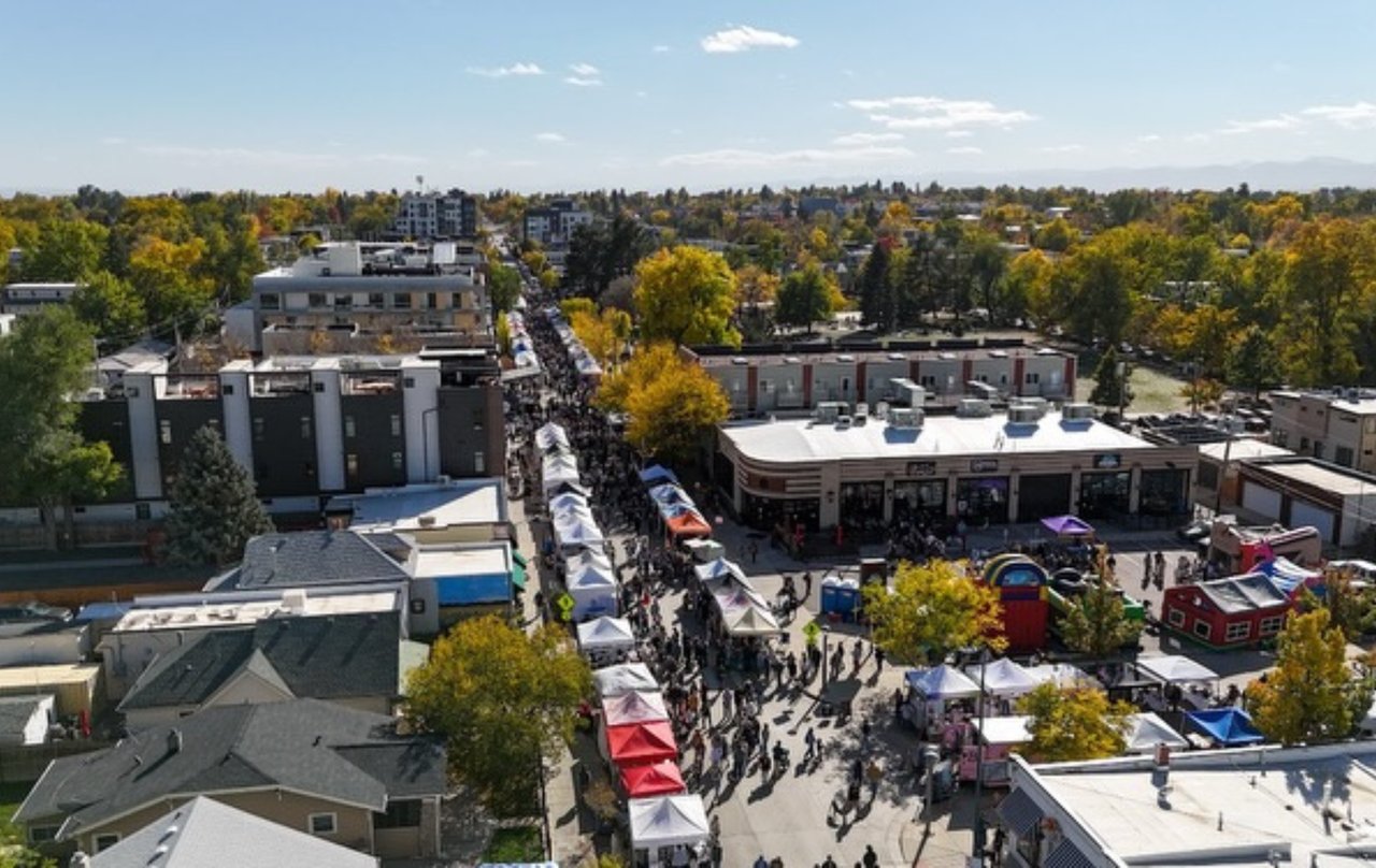 Aerial view of Tennyson Street during a neighborhood street fair in Berkeley, Denver with crowds, local vendors, and storefronts