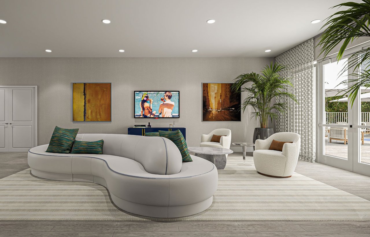 Living room with a curved white sofa, sculptural armchairs, and sliding glass doors to a balcony.