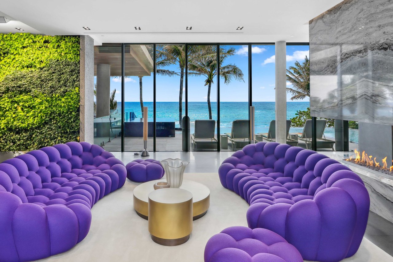 Oceanfront Mansion in Palm Beach county listed by Samantha Curry. Modern living room overlooking Atlantic ocean.
