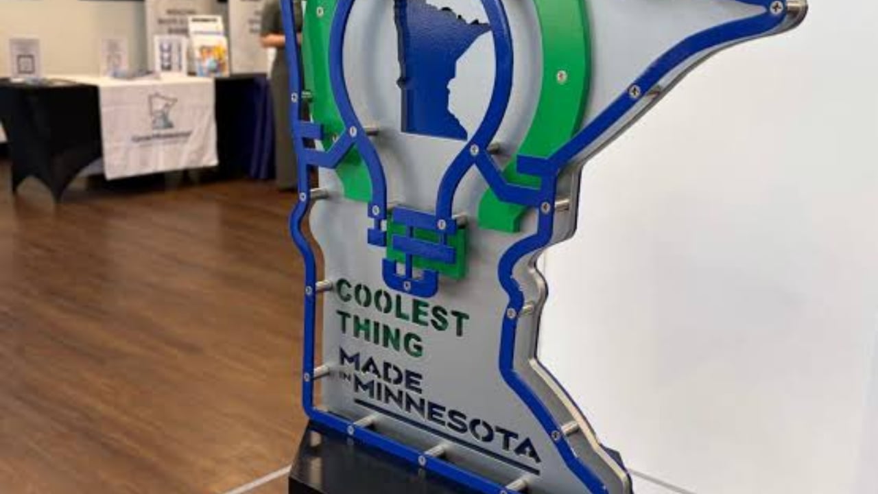 Minnesota-shaped “Coolest Thing Made in Minnesota” award display in blue and green.