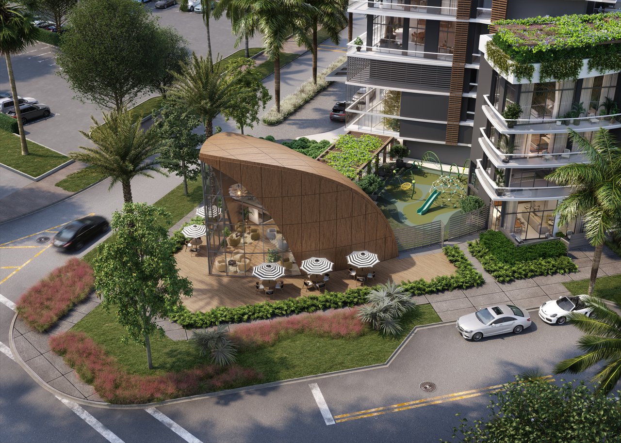 NEXO Residences buildings surrounding a landscaped courtyard with a curved pavilion and children's play area.