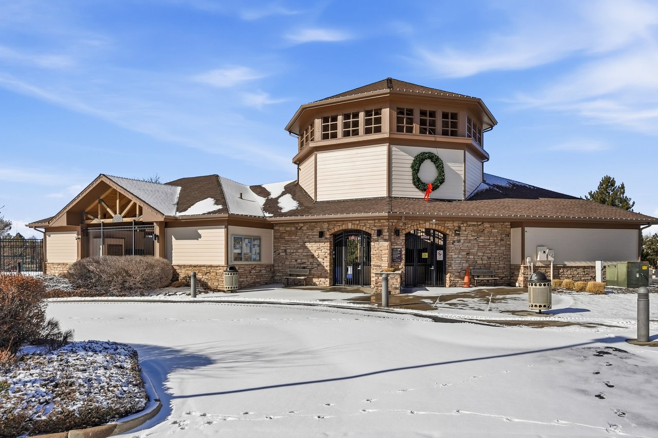 Exterior view of Canterberry Crossing Recreation Center with landscaping and walking paths in Parker, CO.