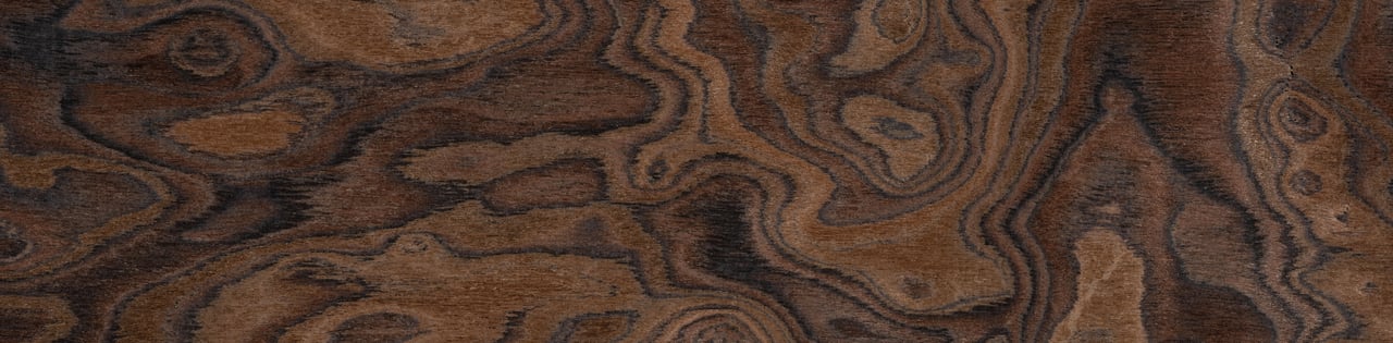 Dark brown wood grain with swirling lines and knots.
