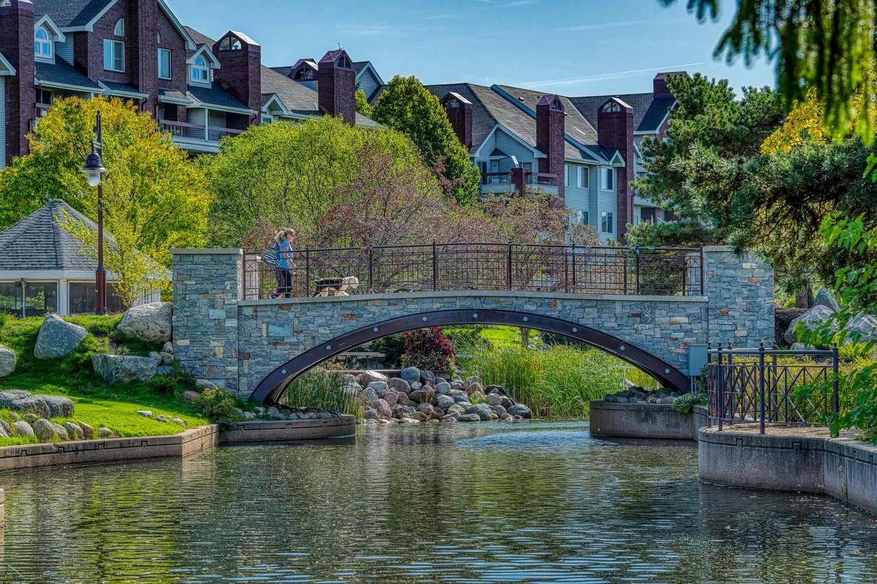 Stone bridge and waterfront walking path at Centennial Lakes Park in Edina