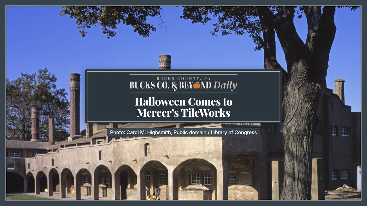 Bucks Co. & Beyond Daily: Halloween Comes to Mercer's TileWorks. The Moravian Pottery and Tile Works in Doylestown on a sunny day, a long stucco building with arched cloisters and tall brick chimneys under a deep blue sky, framed by a large shade tree.