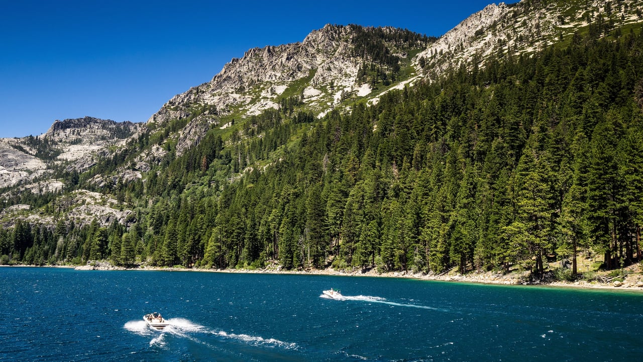 Boat on Lake Tahoe near Incline Village homes with mountains in the background