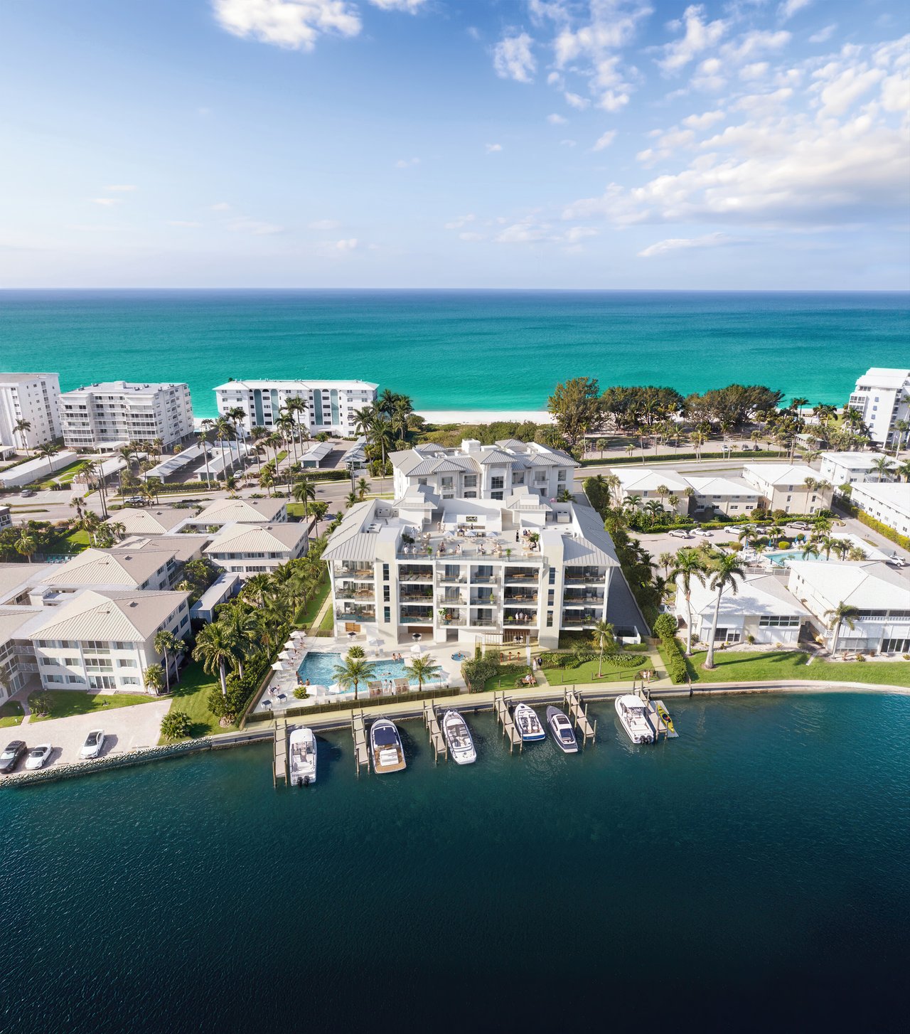 Waterfront condominium with a pool and marina, viewed from above with the Gulf beach beyond.