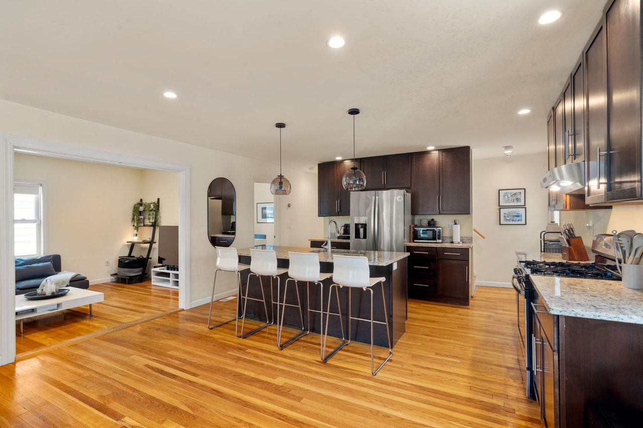 Bright kitchen at 60 French Street in North Quincy with cabinetry and center island
