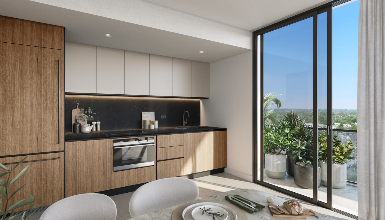Modern kitchen with wood cabinetry, dark stone backsplash, and sliding doors to a planted balcony.