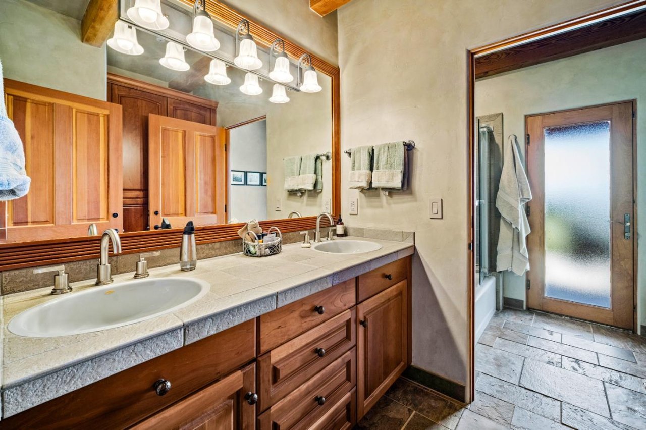 Secondary bathroom featuring a stylish vanity, contemporary fixtures, and natural lighting