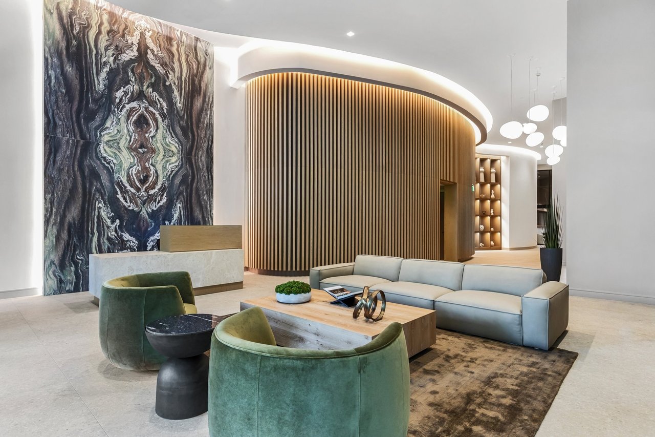 Arbor Coconut Grove lobby lounge with stone feature wall and curved wood partition