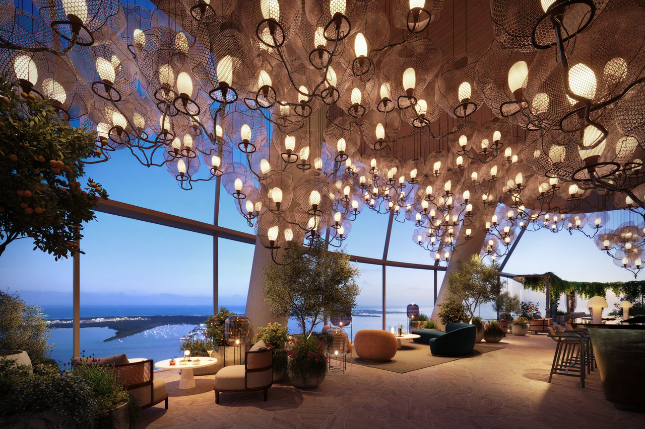 Rooftop terrace with a glowing sculptural light canopy, lounge seating, and a water view.