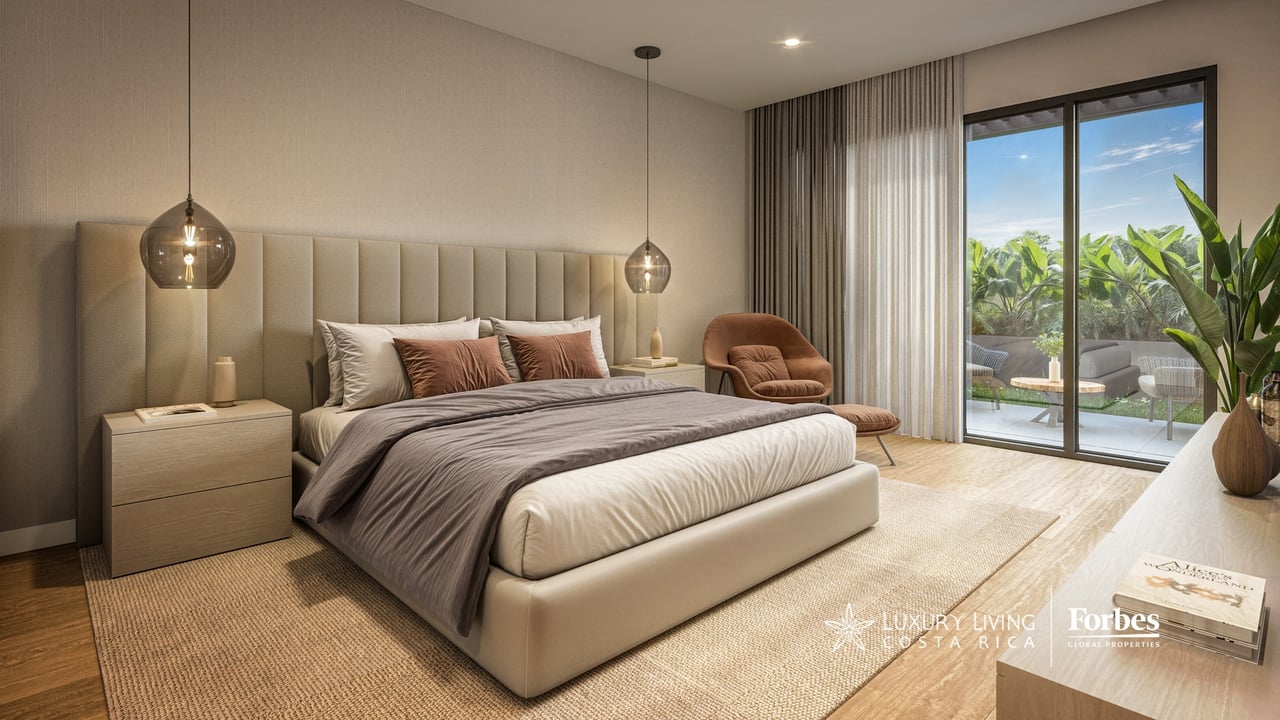 Modern bedroom with a king-size bed and glass doors opening to a tropical patio.