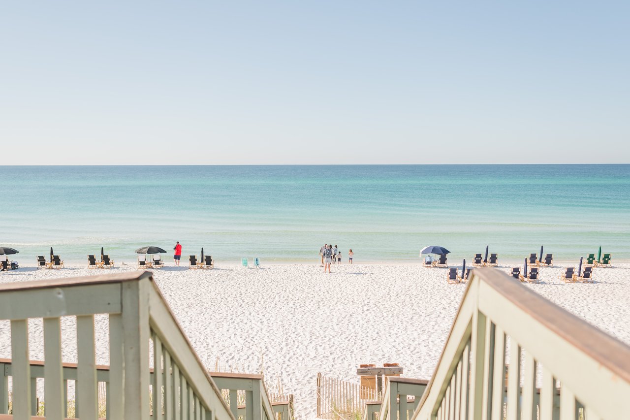 Green-railed dune boardwalk leading over sugar-white sand to the turquoise Gulf at a Seagrove Beach access on 30A, Florida