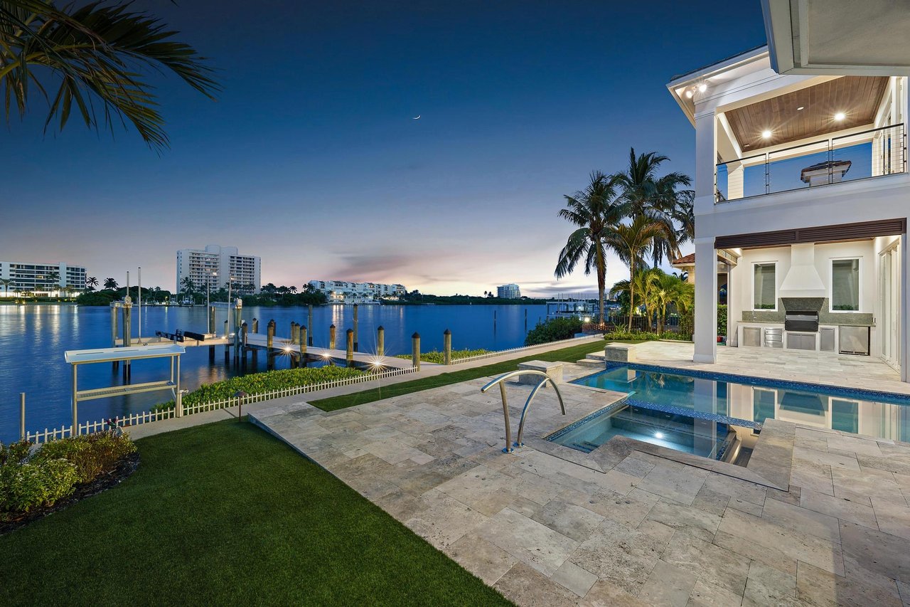 Heated pool and spa with covered outdoor living overlooking wide Intracoastal water at 3433 Harbor Road N in Jupiter Heights, Jupiter, Florida
