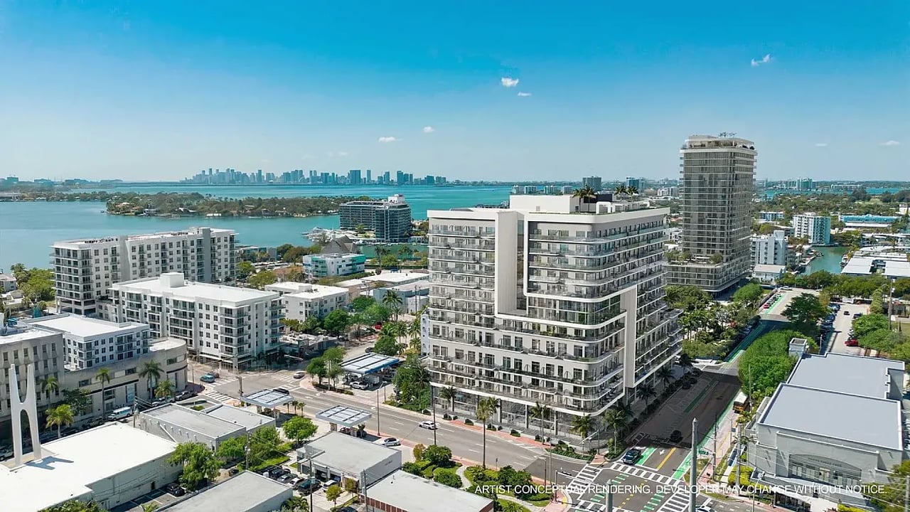 Aerial rendering of NoBe PARC’s waterfront condominium buildings with the city skyline in the distance.