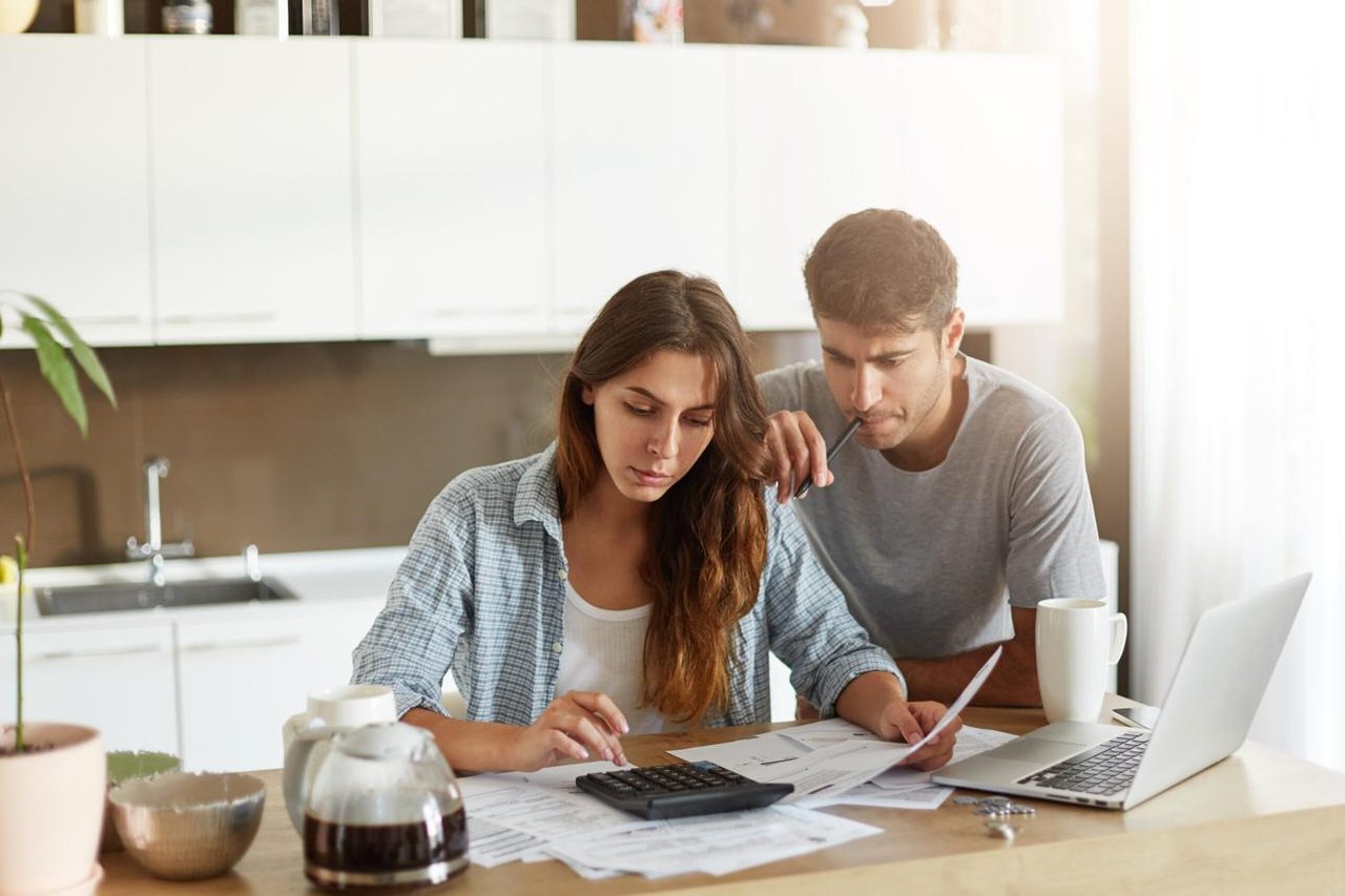 Couple creating a budget before buying their first home in Florida.