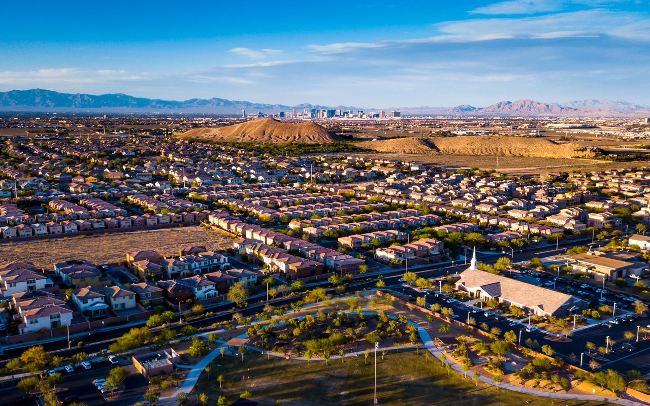 Las Vegas neighborhoods stretch toward the downtown skyline and desert mountains.