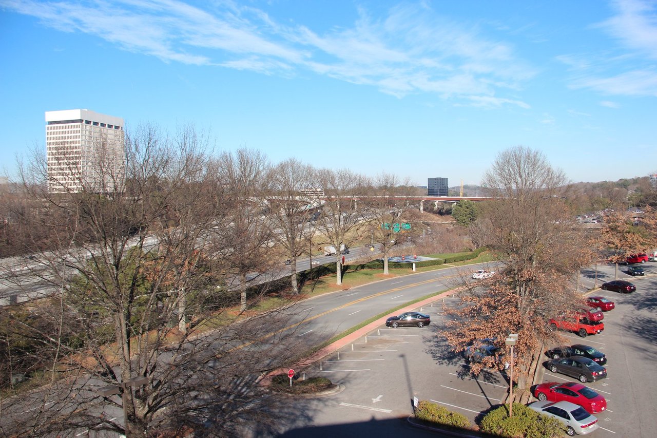 Cobb Cloverleaf interchange: I-75 ramps and an overpass seen from above, with parking lots and trees alongside