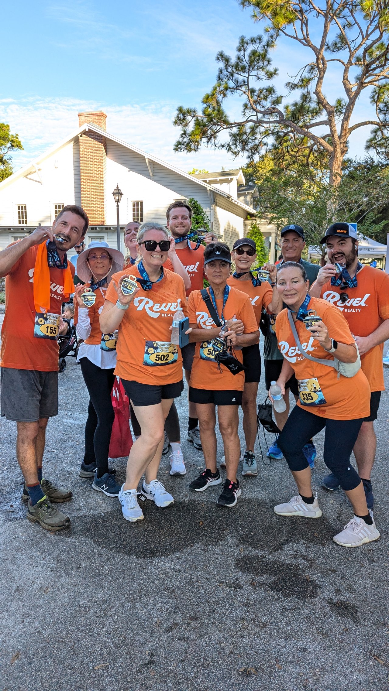 Revel Realty agents celebrate after running in the 2024 Run Among the Lakes Windermere Florida 5k