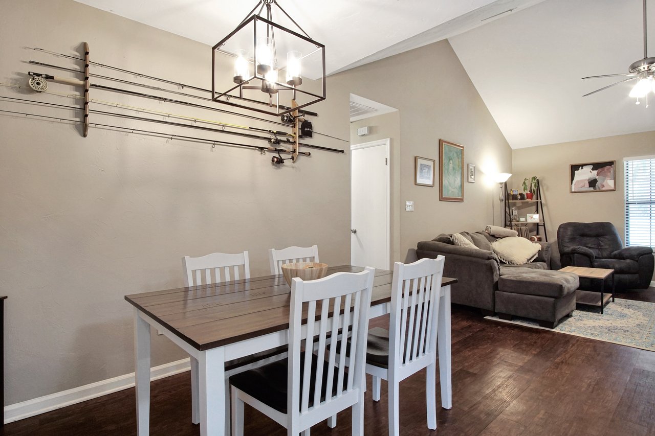 A dining room featuring a table surrounded by chairs, creating an inviting space for meals and gatherings.