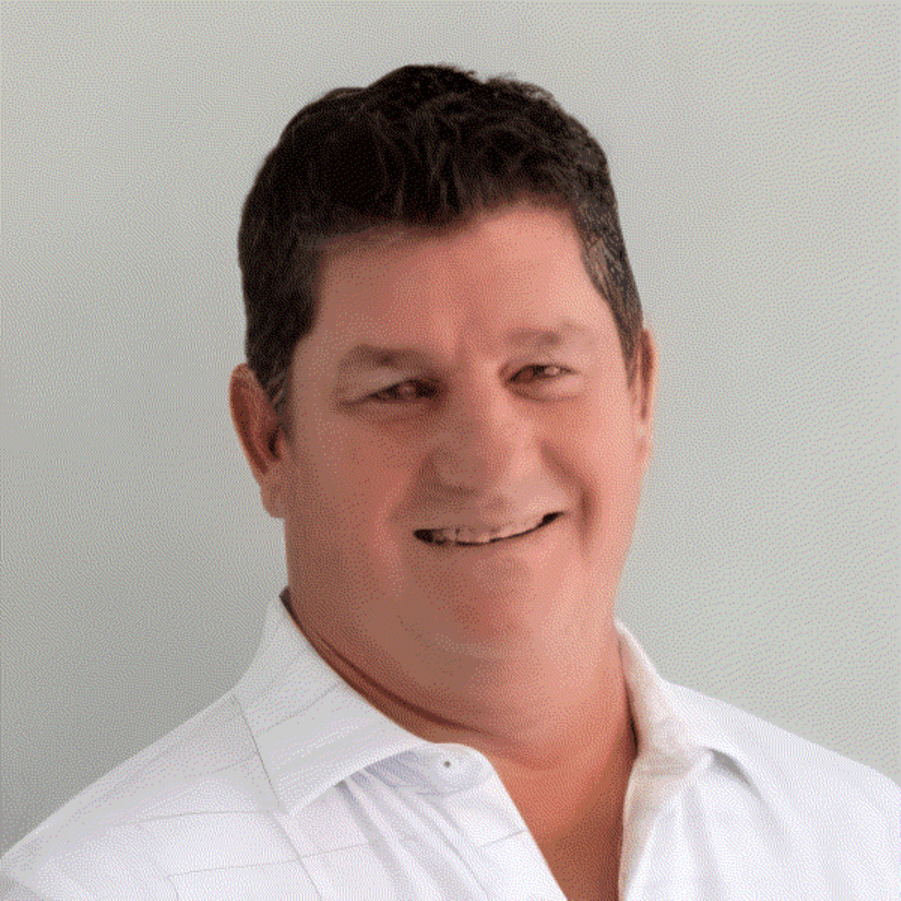 David Swart, smiling in a white collared shirt