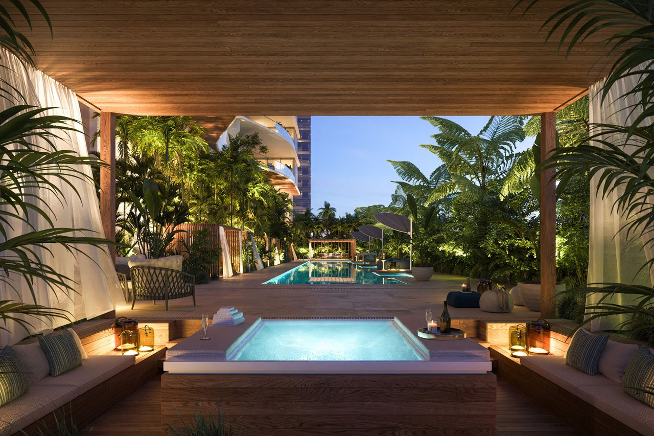 Pool terrace with a foreground spa, tropical plants, and a broad wood canopy.