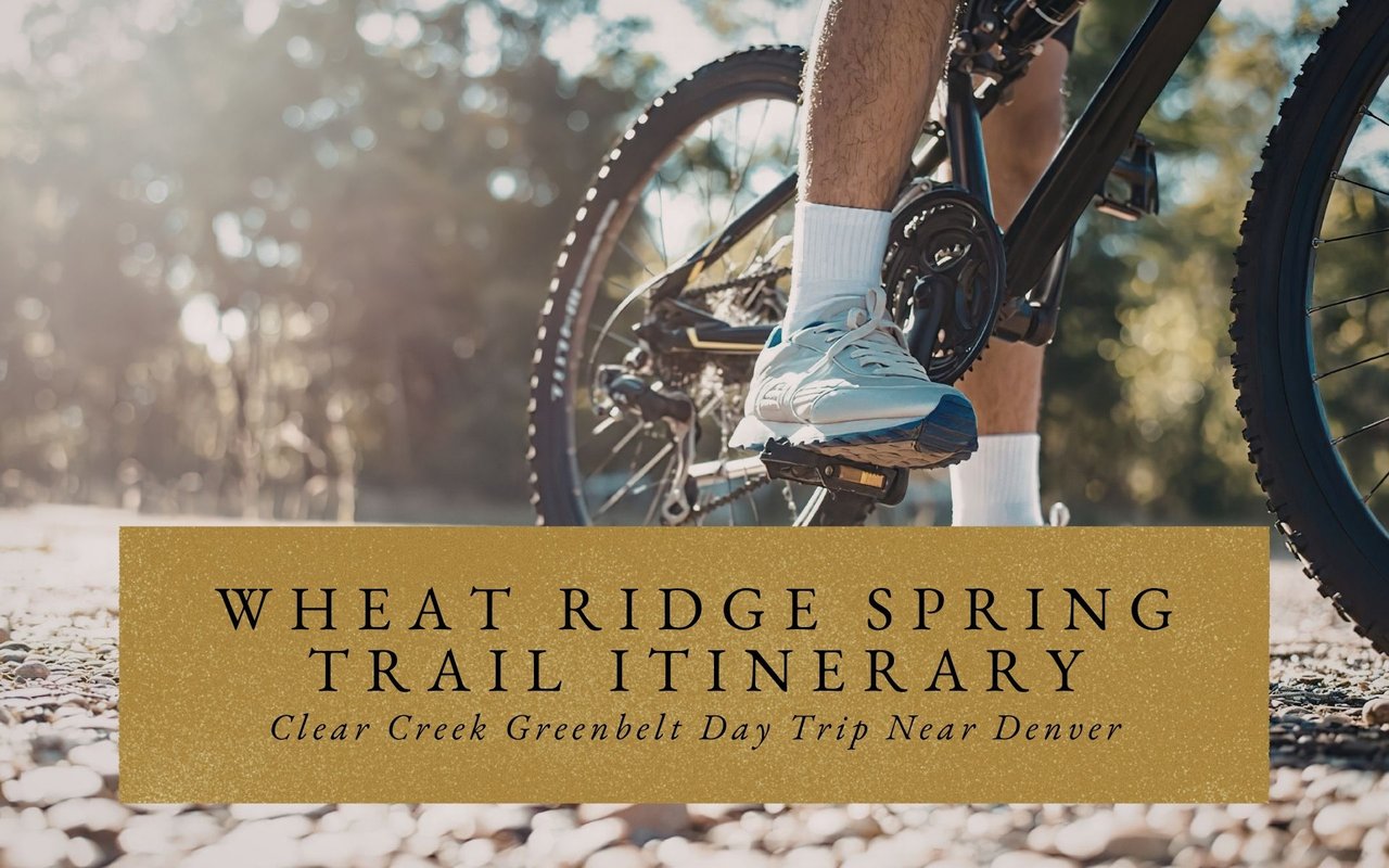 Cyclist riding along a flat, paved trail in Wheat Ridge with the Front Range mountains faintly visible in the distance.