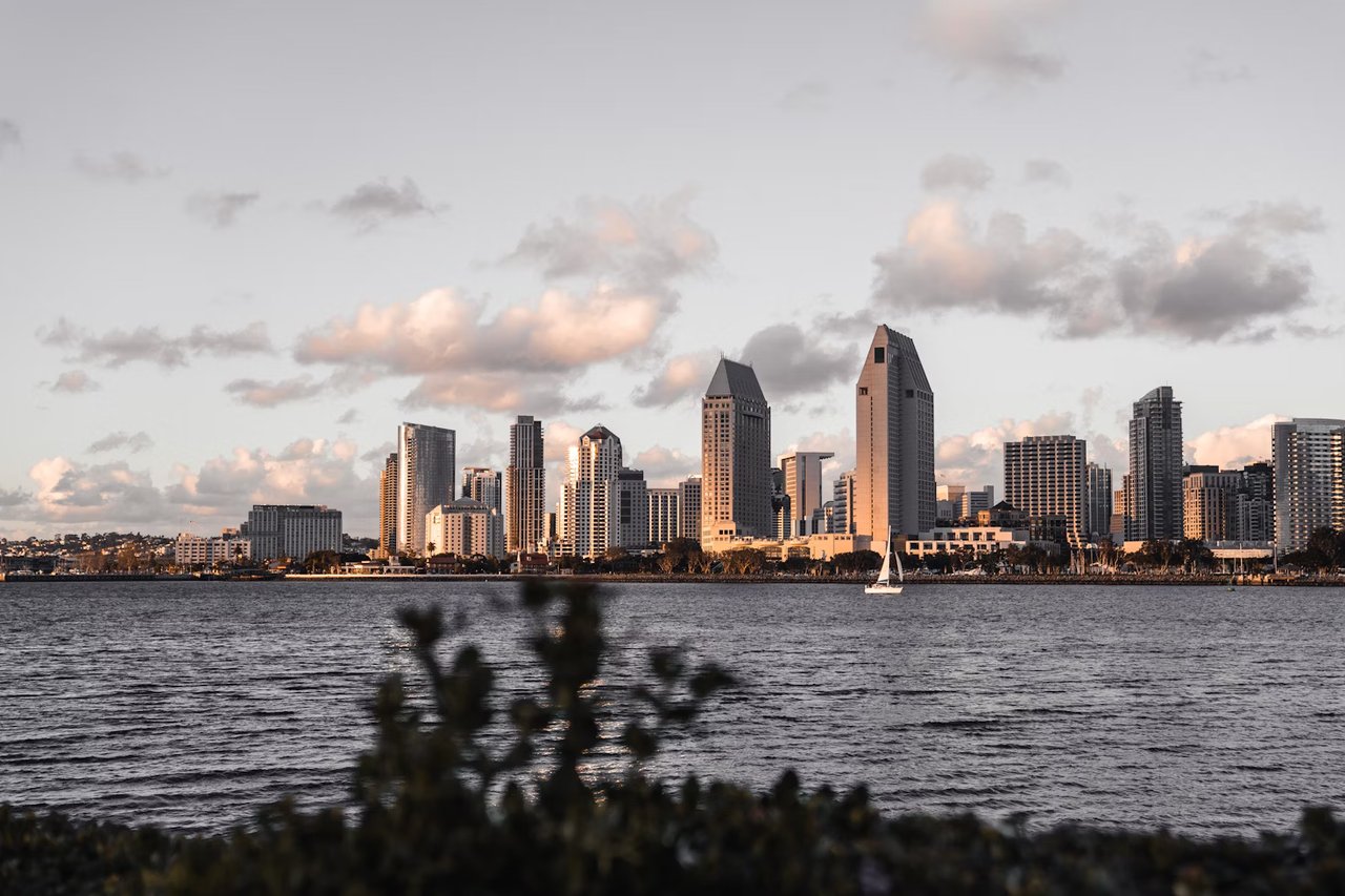 Elegant San Diego beachfront sunset with skyline view, reflecting the luxury real estate vision of Amy Ali and Agency West