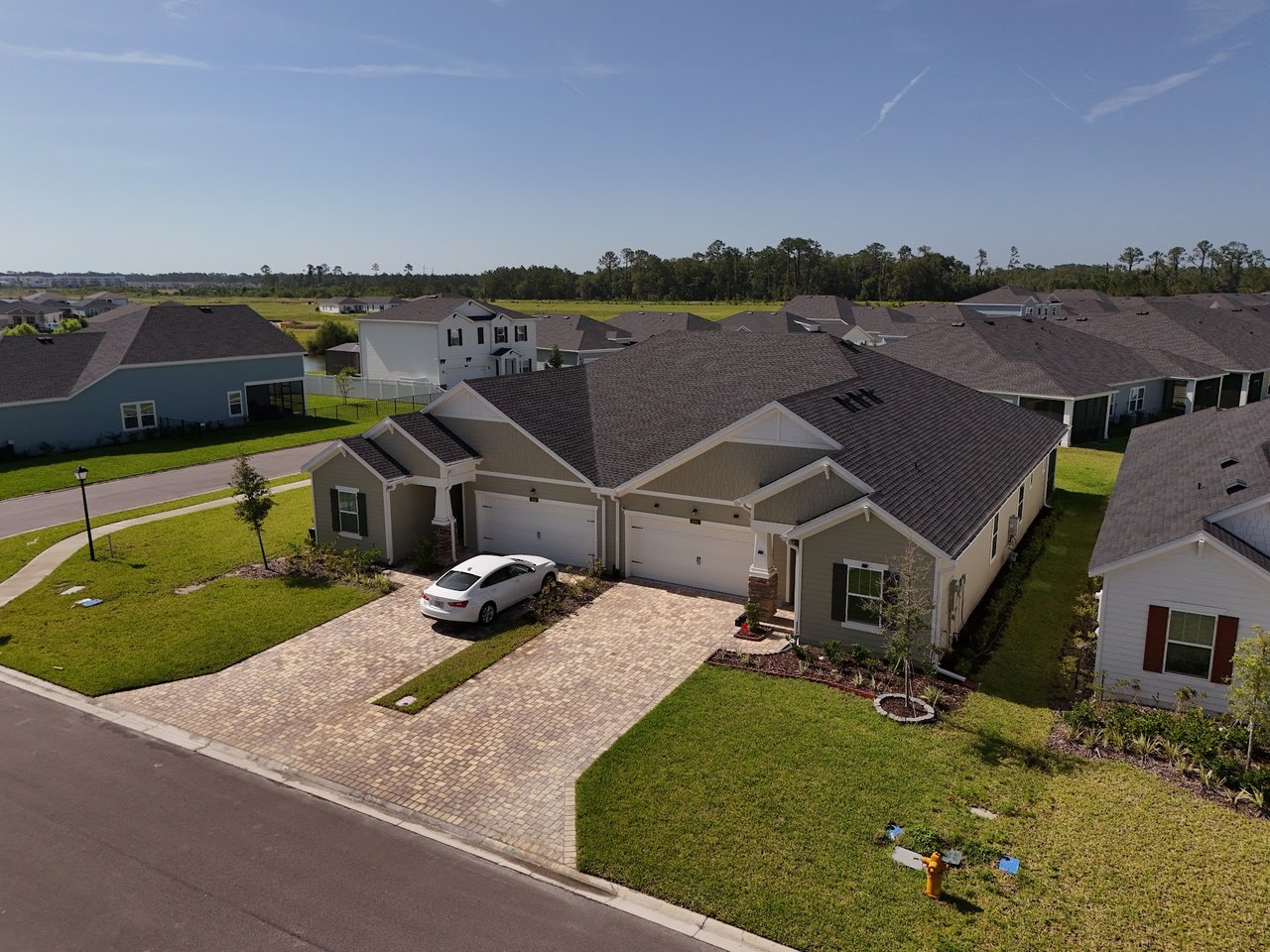 Aerial view of Silver Meadows homes with paved driveways and green lawns.